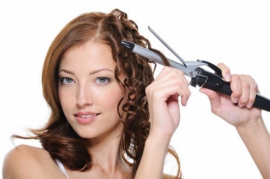 curling female brunette hair with roller